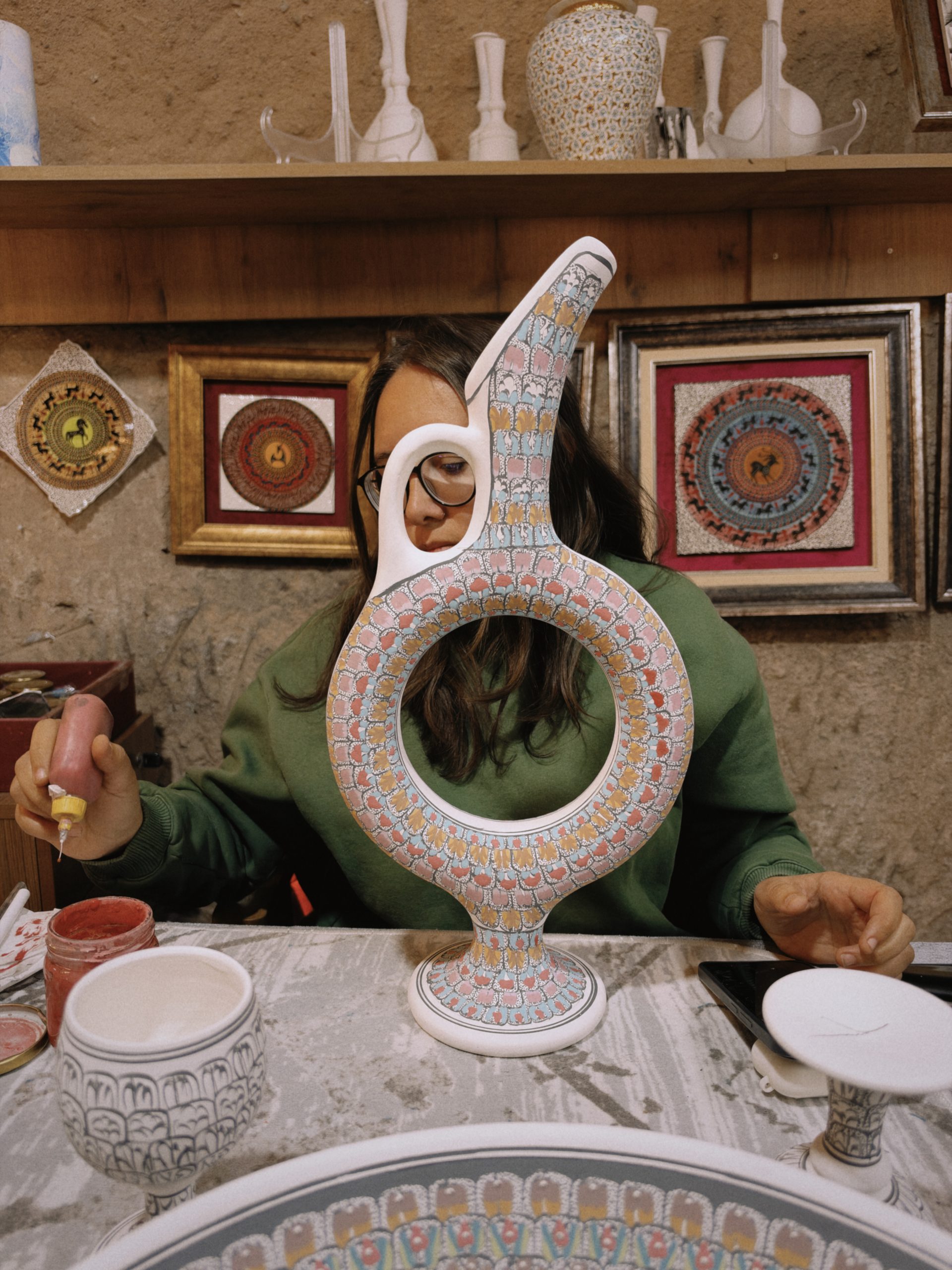 Artist hand decorating an ornate ceramic vase in Cappadocia