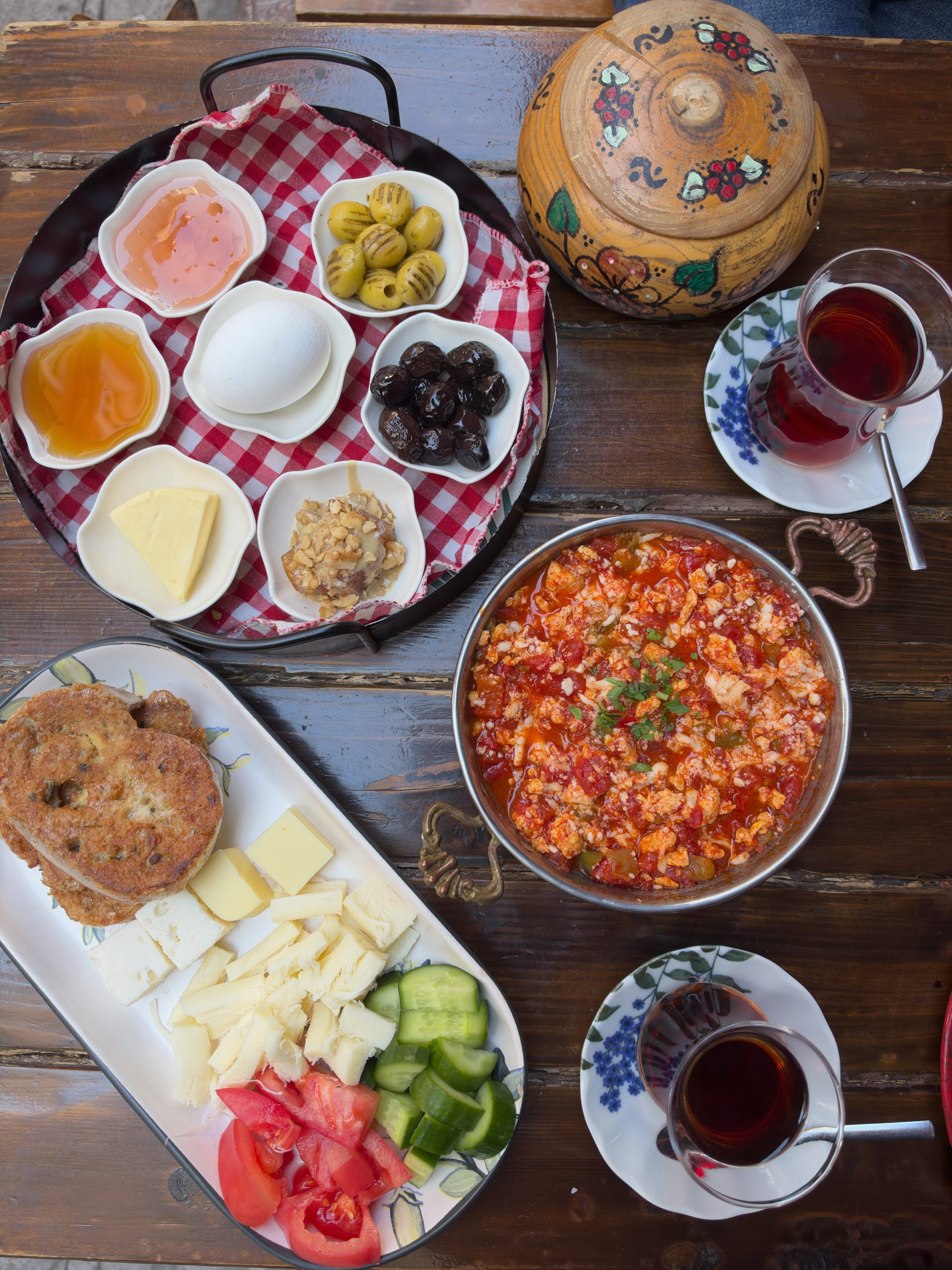 Traditional Turkish breakfast with tea, menemen, bread, cheese and small dishes
