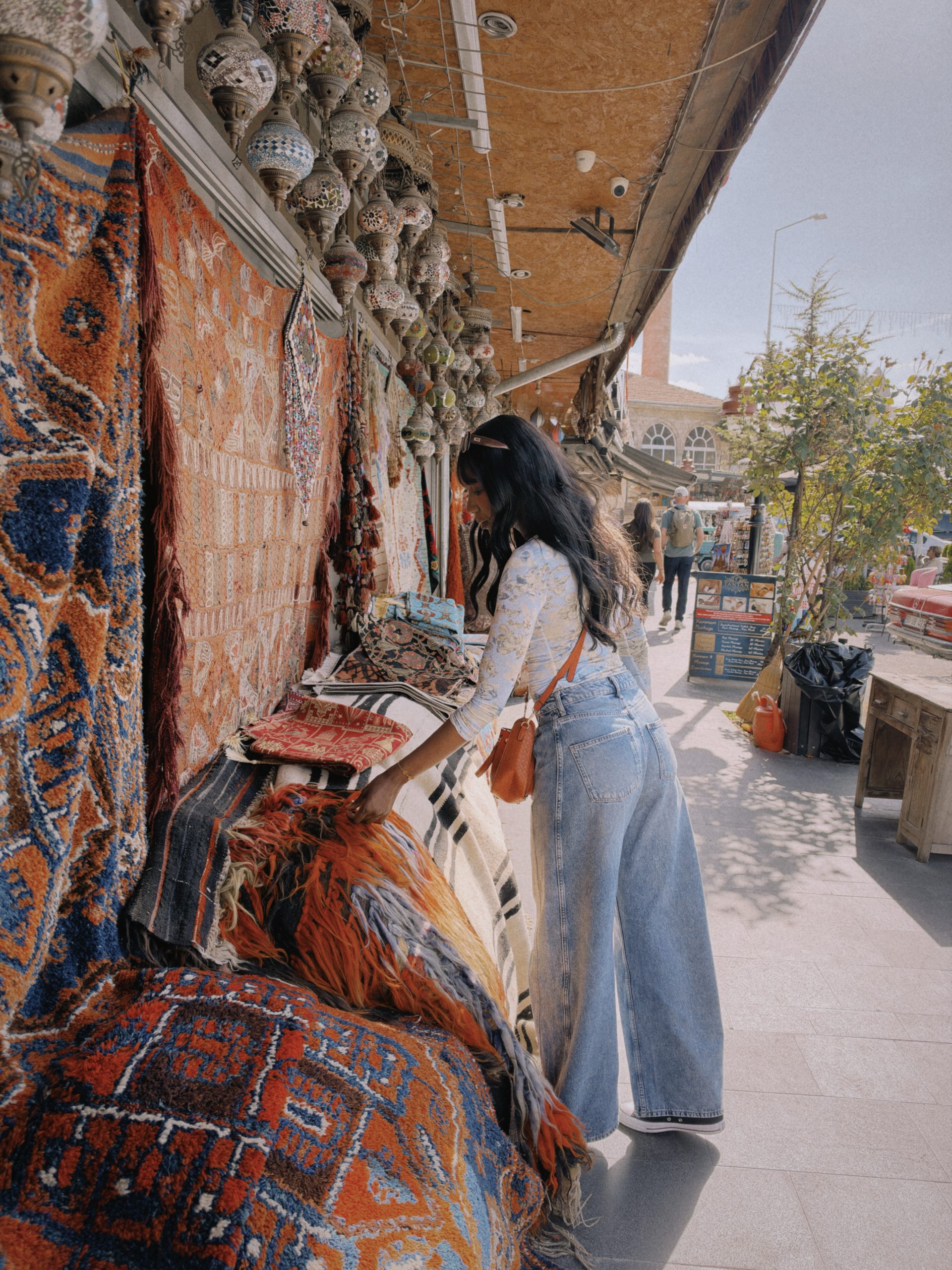 Woman shopping in a Turkish rug market