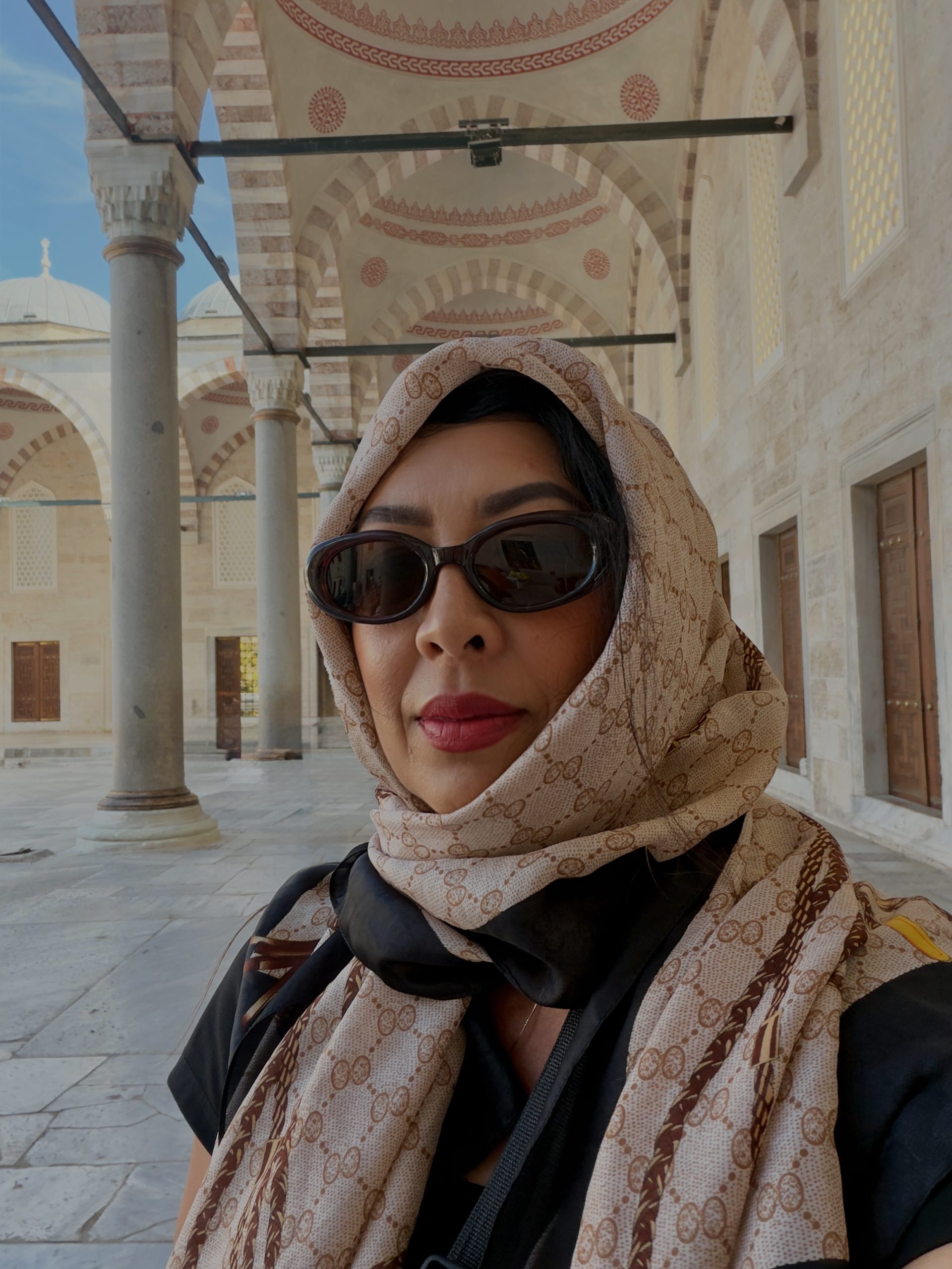 Woman wearing a headscarf in an Istanbul mosque courtyard